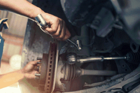 A Mechanic Repairing a Car Suspension in Portland, OR