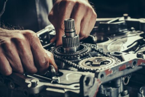 Man works on MINI Cooper engine, marking the end of manual transmission era for the iconic car