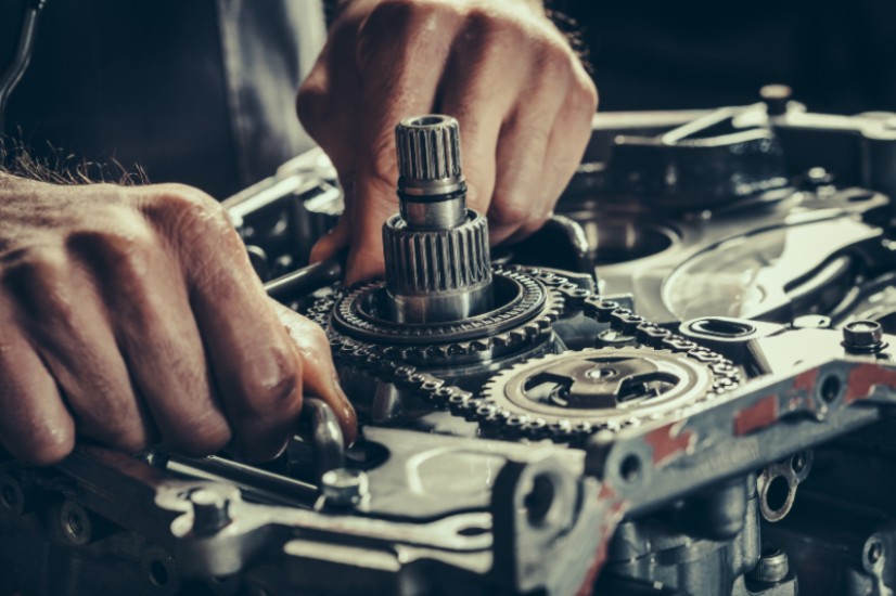 Man works on MINI Cooper engine, marking the end of manual transmission era for the iconic car