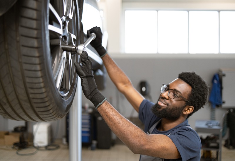 Genuine MINI Mechanic Servicing a Car In Portland, OR
